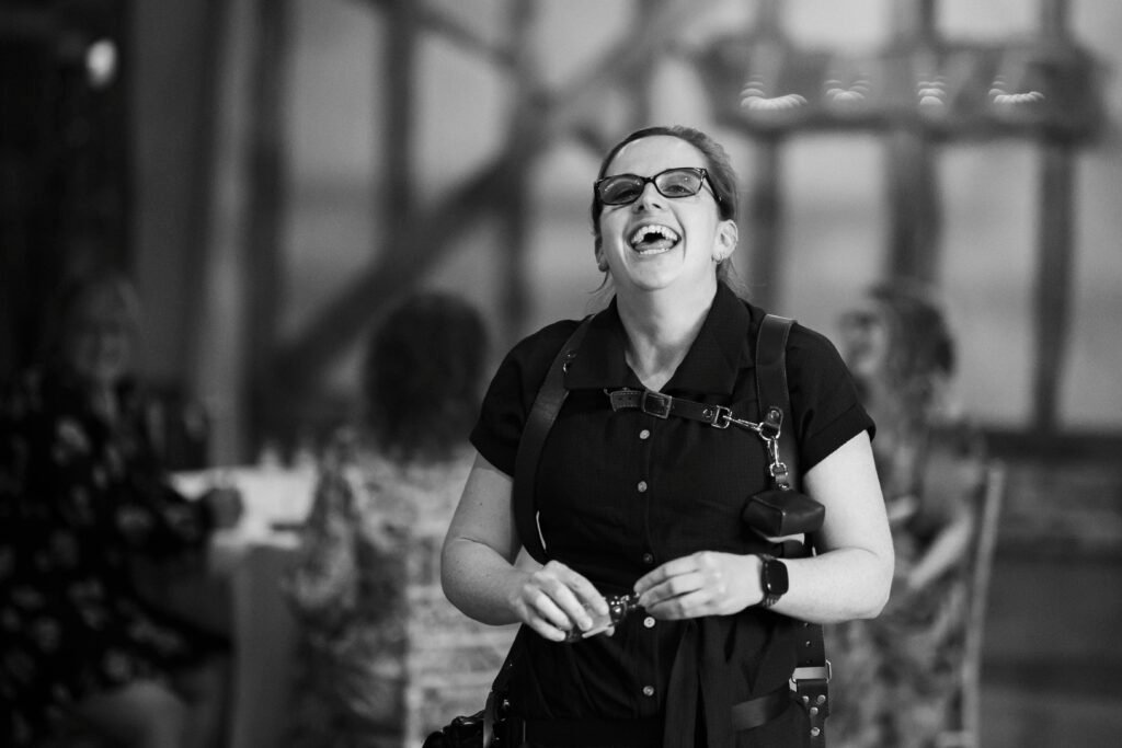 Behind the scenes with Polly Hart Photography laughing at wedding