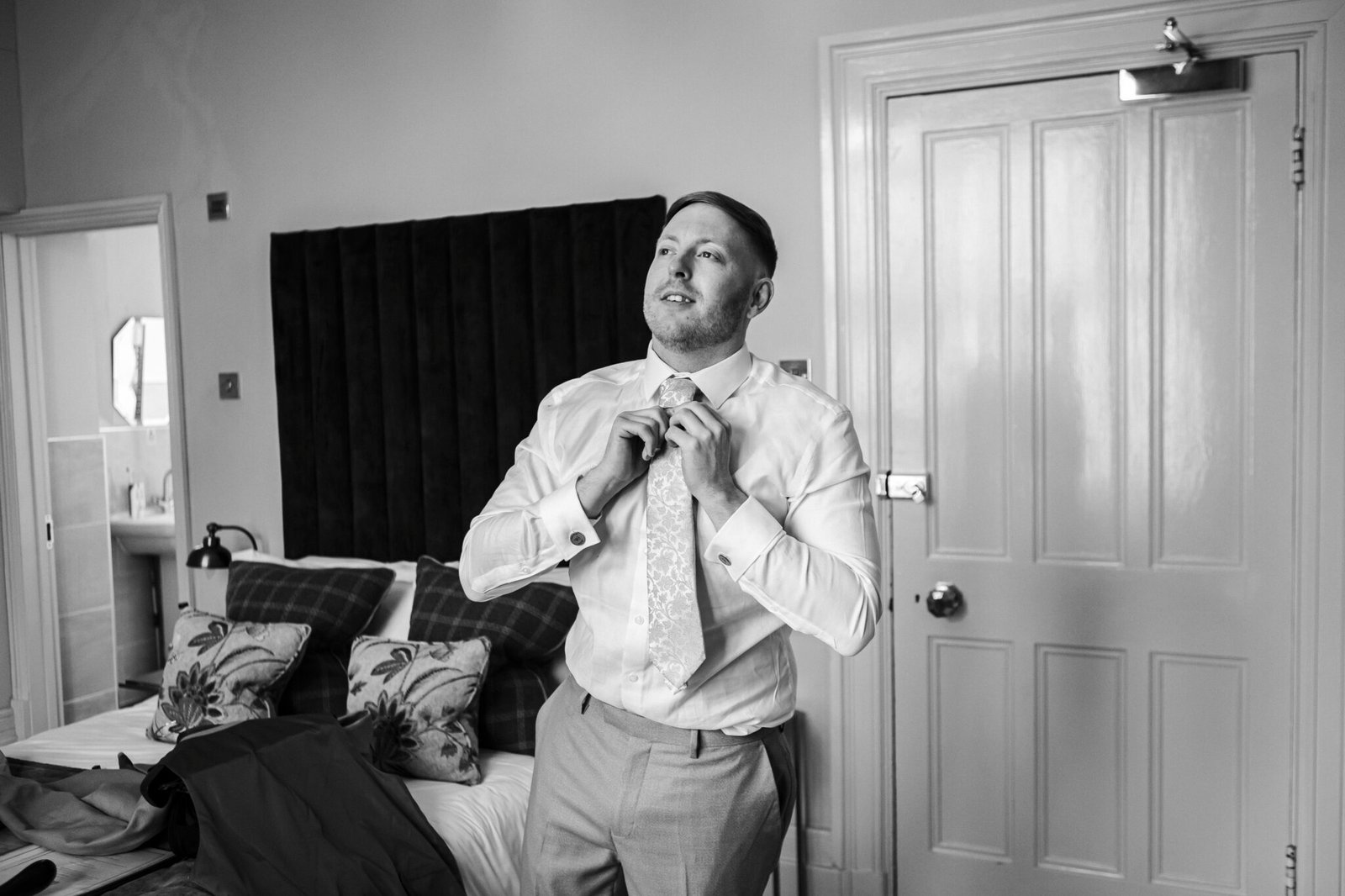 Groom preparations at Holmewood Hall captured by Cambridge wedding photographer