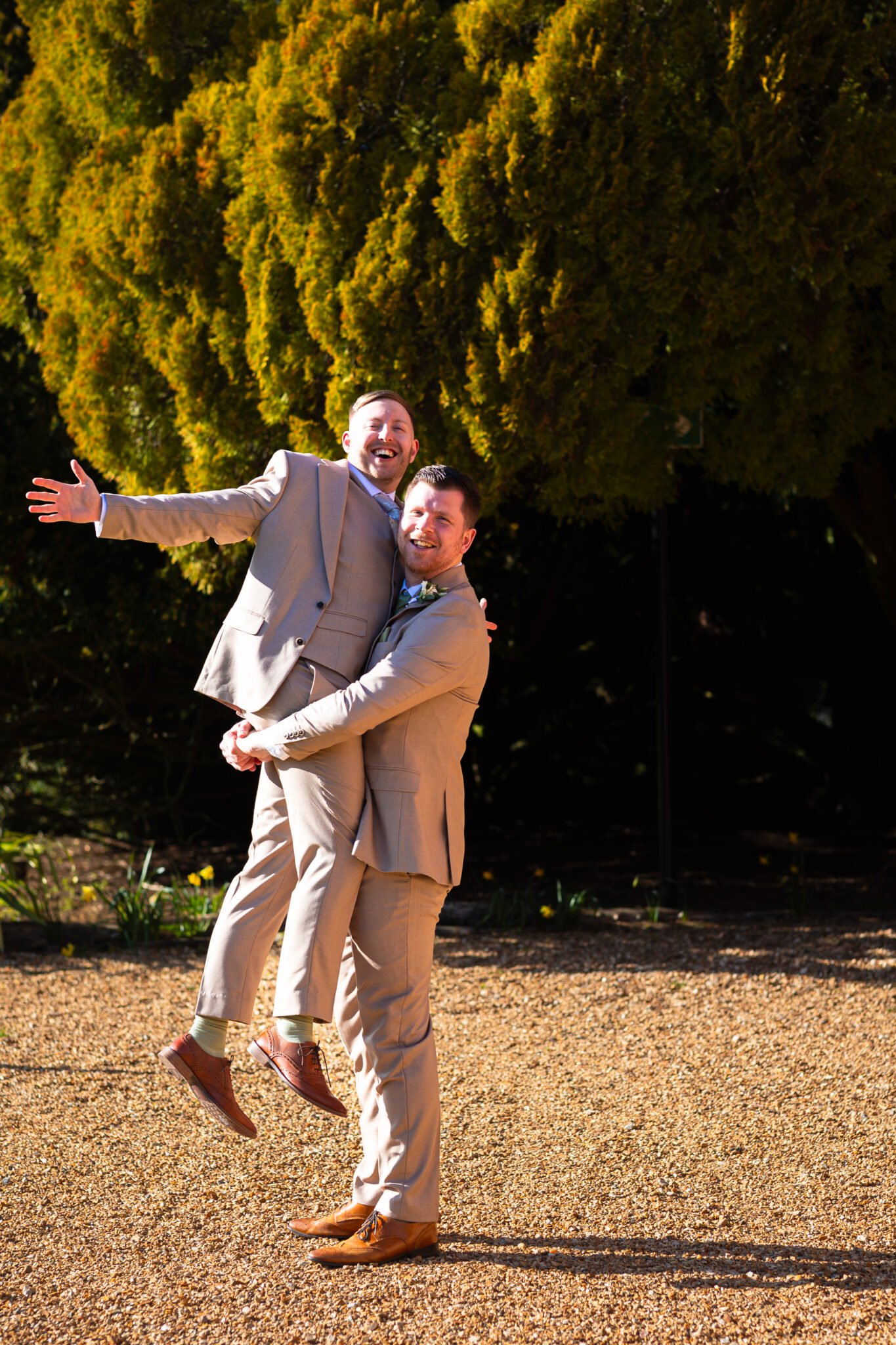 Guests celebrating outside Holmewood Hall wedding venue Natural wedding photography at Holmewood Hall