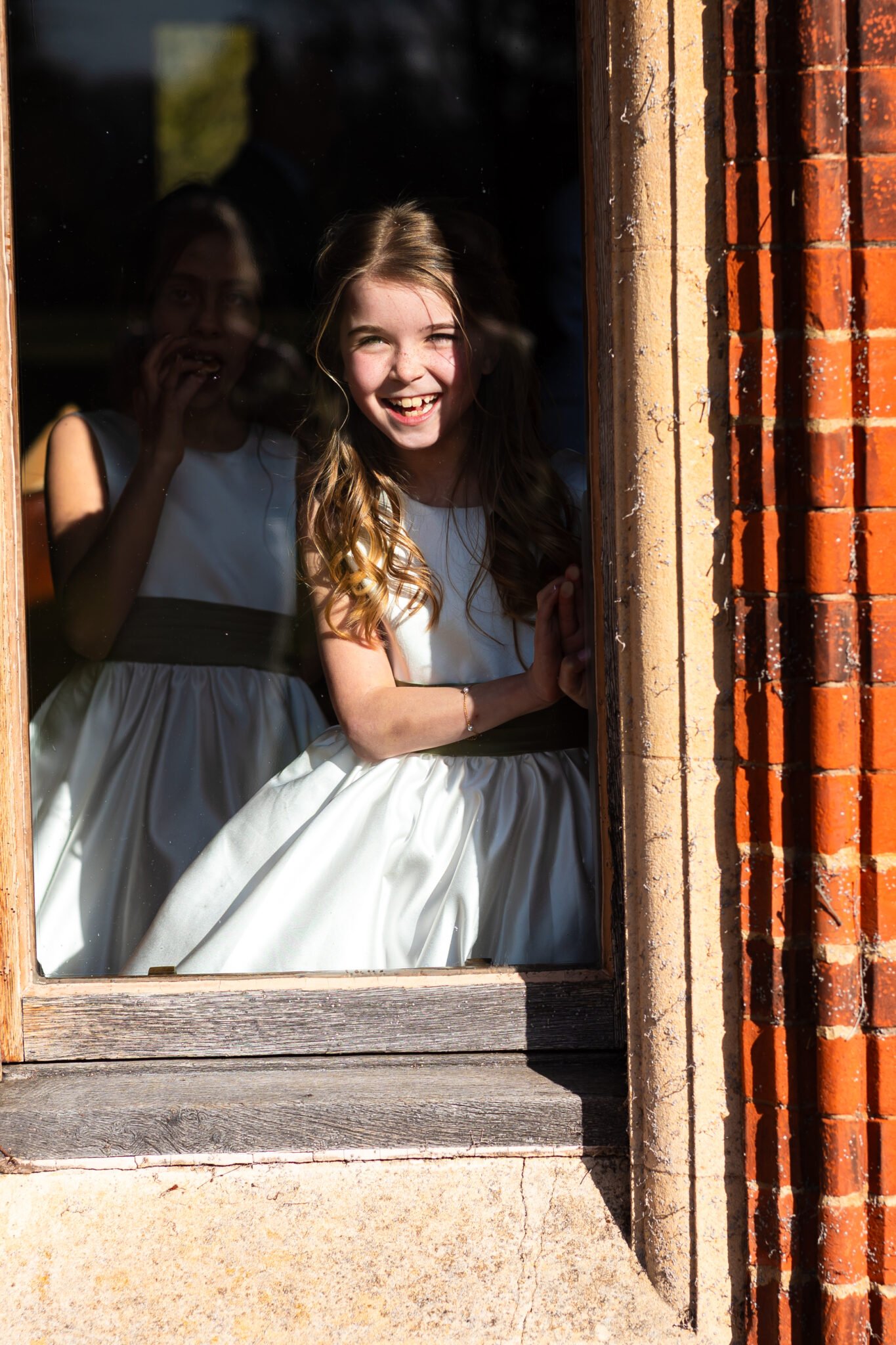 Guests celebrating outside Holmewood Hall wedding venue Natural wedding photography at Holmewood Hall